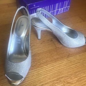 Open-toe silver sling-back heels.